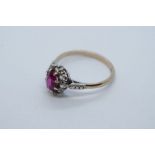 9ct yellow gold ruby and paste set cluster ring with central oval mixed cut ruby surrounded clear st