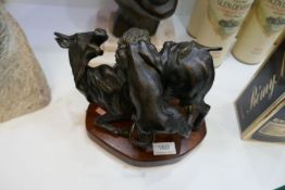 A 20th Century bronze sculpture of lion attacking buffalo on mahogany shaped plinth