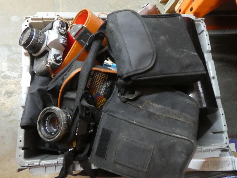 A large box containing vintage cameras, binoculars of various manufacturers and ages