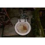 An vintage marine toilet with pump mechanism and a teak chair