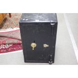 An early 20th century bank safe, black painted, with key