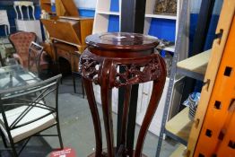 A modern Chinese hardwood stand having carved decoration.