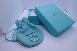 TIFFANY & CO;  A boxed silver ring by Tiffany & Co., marked 925, with ring box, gift bag and origina