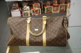 Louis Vuitton; a Louis Vuitton travel bag