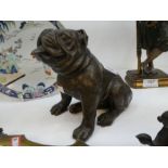 A modern bronze sculpture of seated bulldog