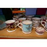 A large selection of china mugs mostly depicting themes of the British Royal family including Britan