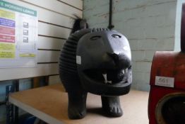 A large carved wooden African style lion, with hair tail