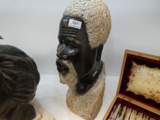 An African stone sculpture of bearded men, height 47cms