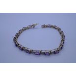 10ct fancy yellow and white gold bracelet with 19 oval amethyst stones each separated floral link wi