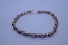 10ct fancy yellow and white gold bracelet with 19 oval amethyst stones each separated floral link wi