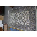 A fine Kashan rug having repeated floral design in a cream field, 207 x 140 cms