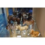 A shelf of Beswick Horse and Donkey figures
