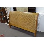 A modern good quality king size bedstead, the headboard having cane decoration