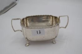 A silver tea service by J W Benson Ltd having four feet, comprising teapot, two handled sugar bowl,