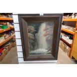 A framed and glazed picture of a waterfall