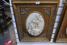 Two framed resin plaques depicting cherubs