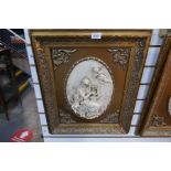 Two framed resin plaques depicting cherubs