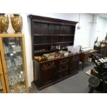 1 19th century style oak dresser and rackback having three drawers with cupboards below, 181cms