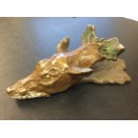 A cold painted bronze fox letterclip, the hinged sprung head cast with leaves. (5.75in)
