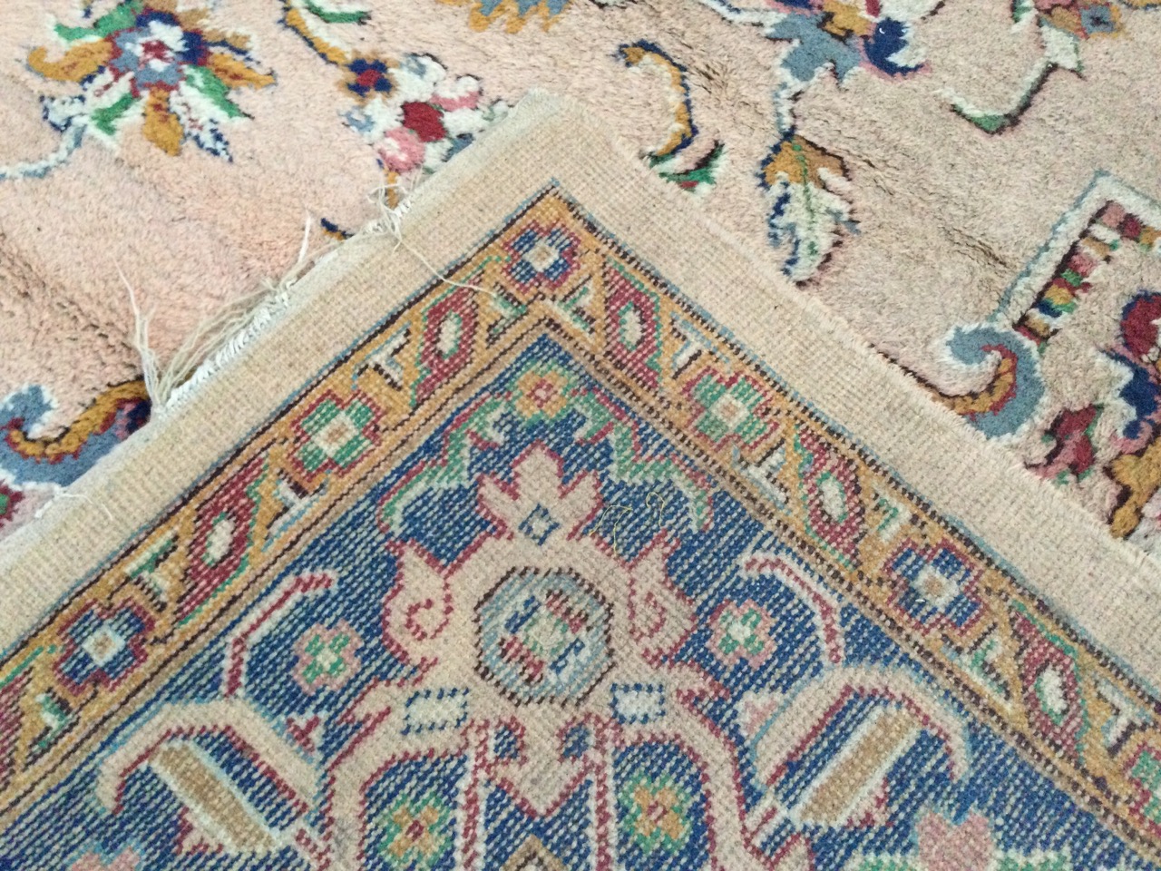 An Axminster wool carpet woven in the eastern Persian manner with central floral medallion on fawn - Image 3 of 3