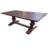 A rectangular oak refectory table, the dowelled plank top with cleated ends raised on trestle