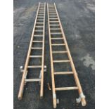 A two section wood extension ladder, each piece with 18 turned re-inforced rungs. (189in)