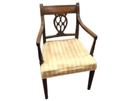 A nineteenth century mahogany open armchair with tablet back rail above a pierced carved