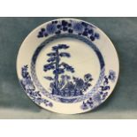 An eighteenth century Chinese delft tin glazed plate decorated with tree, garden fence & flowers