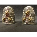 A pair of silver plated cruets modelled as beehives, the ribbed salt & pepper pots with applied gilt