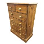 A reproduction pine chest of drawers with rectangular moulded top above two short and four long