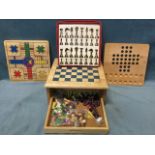 A games chest with pull-out playing boards above a drawer with pieces and instructions - Chinese