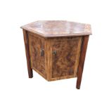 An hexagonal burr walnut style coffee table, with moulded panelled top above a two-door cupboard,