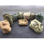 A quantity of army kit bags containing sleeping bags, coats, jackets, a 1962 quilted survival bag, a