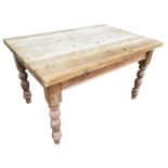 A rectangular pine kitchen table with thick plank top on turned legs, having one end with knobbed