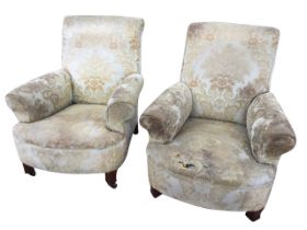 A pair of 1950s upholstered armchairs with high backs and flared arms above sprung upholstered