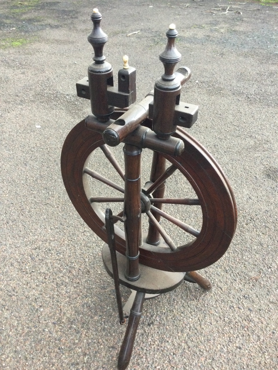 A nineteenth century mahogany spinning wheel with turned spindles raised above an oval platform with - Image 2 of 3