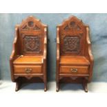 A pair of late Victorian carved walnut wallshelves with small drawers having arched moulded backs