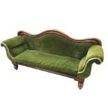 A Victorian mahogany parlour sofa with serpentine shaped moulded back and scrolled padded arms