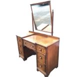 A carved oak dressing table, the mirror frame and tabletop with dentil mouldings, having central