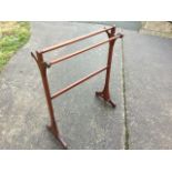 A late Victorian mahogany towel stand with four rails on rectangular supports with triangular circle