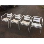 A set of four tubular aluminium framed garden armchairs with ribbed slatted backs and seats. (4)