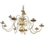 A large Dutch style brass chandelier with twelve scrolled branches around a column with ball