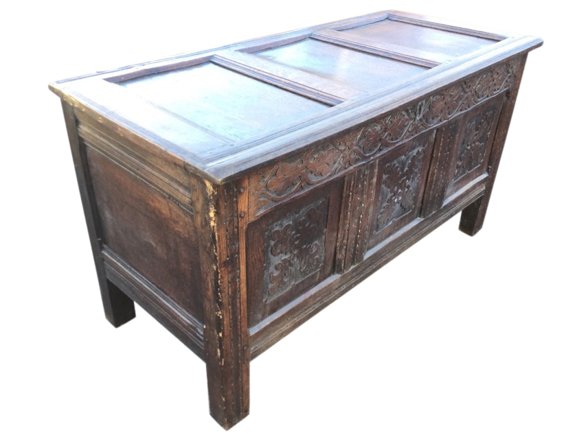 A nineteenth century carved oak coffer with three moulded panels to hinged top, the front with blind