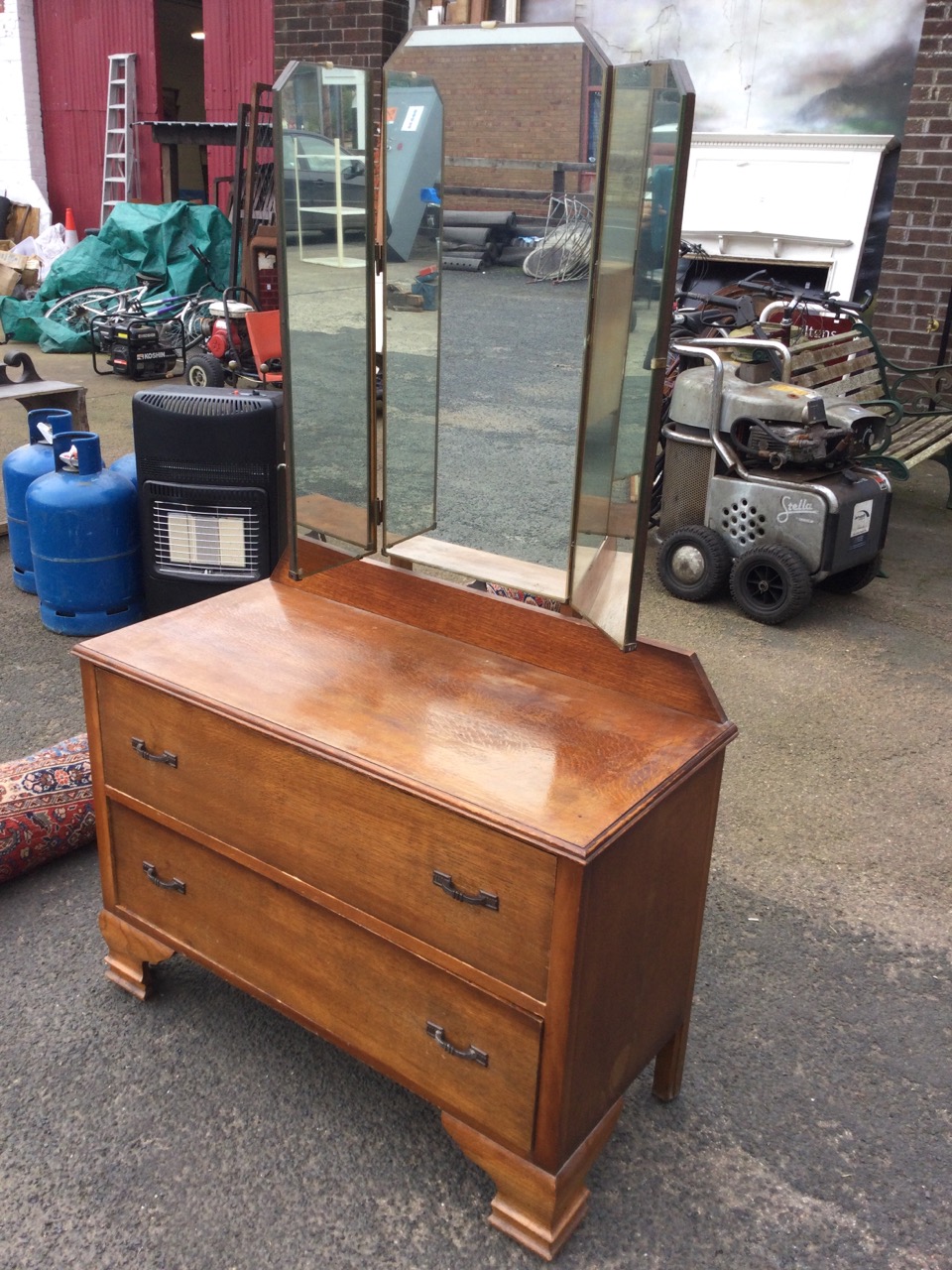An oak dressing table with easel mirror to top flanked by hinged wings, the chest with two long - Image 3 of 3