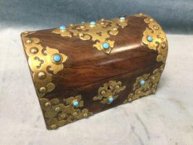 A Victorian walnut tea caddy with pierced celtic style brass mounts set with turquoise cabochon