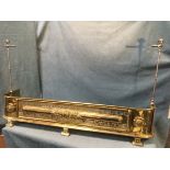 A nineteenth century country house brass fender mounted with steel firetool stands, with moulded