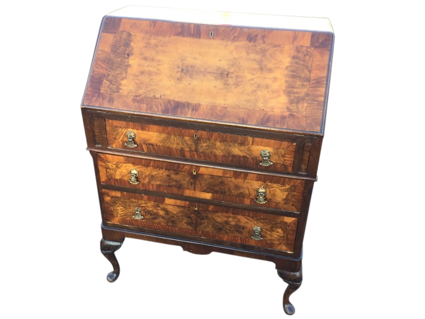 A Queen Anne style walnut bureau with crossbanded fallfront enclosing a fitted interior with two