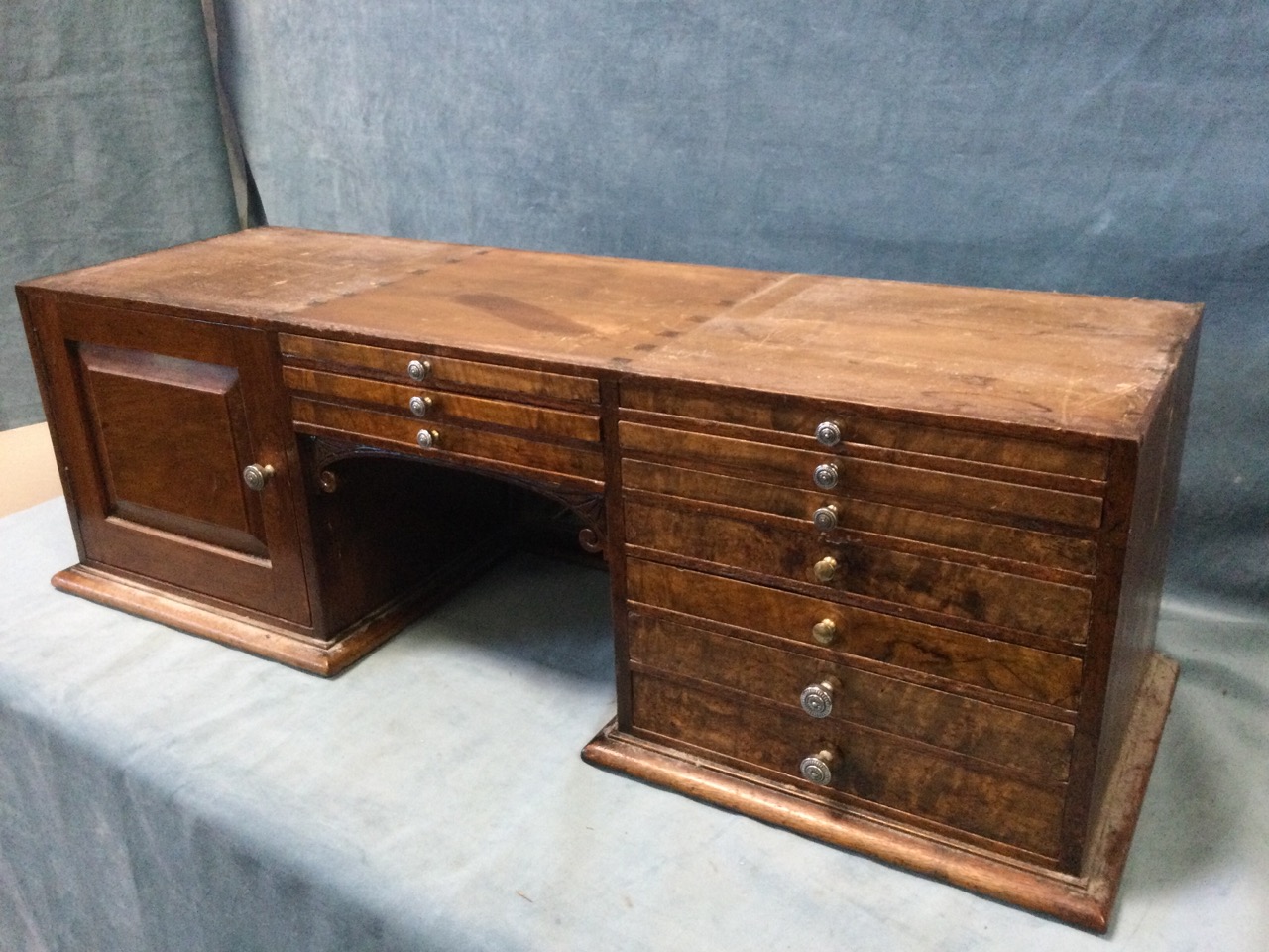 A late Victorian table-top walnut collectors cabinet, with central mirror-back having scroll