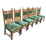 A set of six late Victorian oak dining chairs, the foliate scroll carved backs with handholes