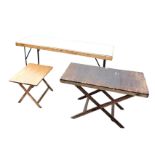 A rectangular folding decorators table; another folding table with plank top; and a third with later